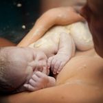 Newborn baby in waterbath