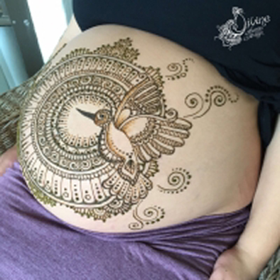 Henna art on pregnant belly